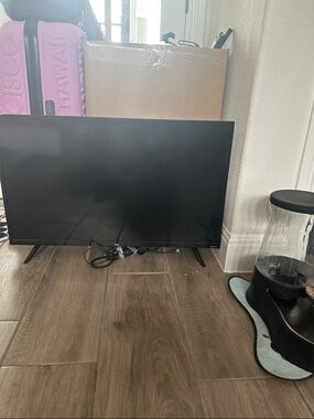 TLC and Roku Black Flat Screen TV with Slim Bezel